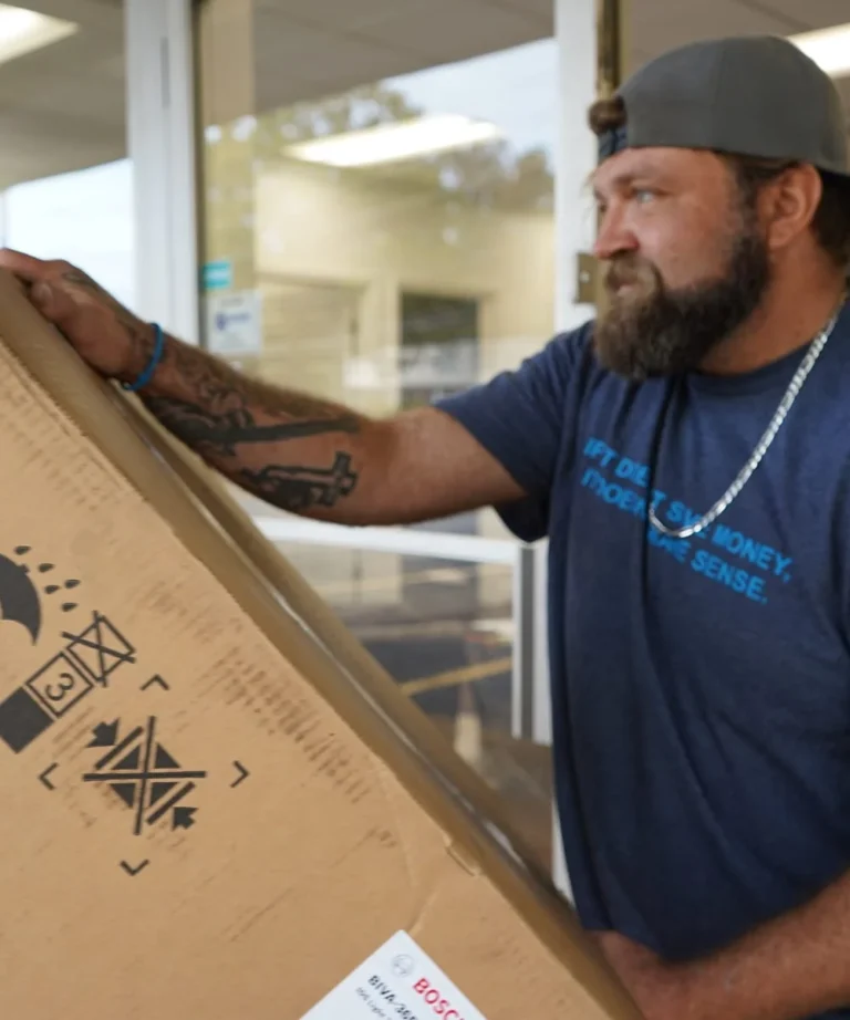 Cool Breeze technician handling new air conditioning equipment