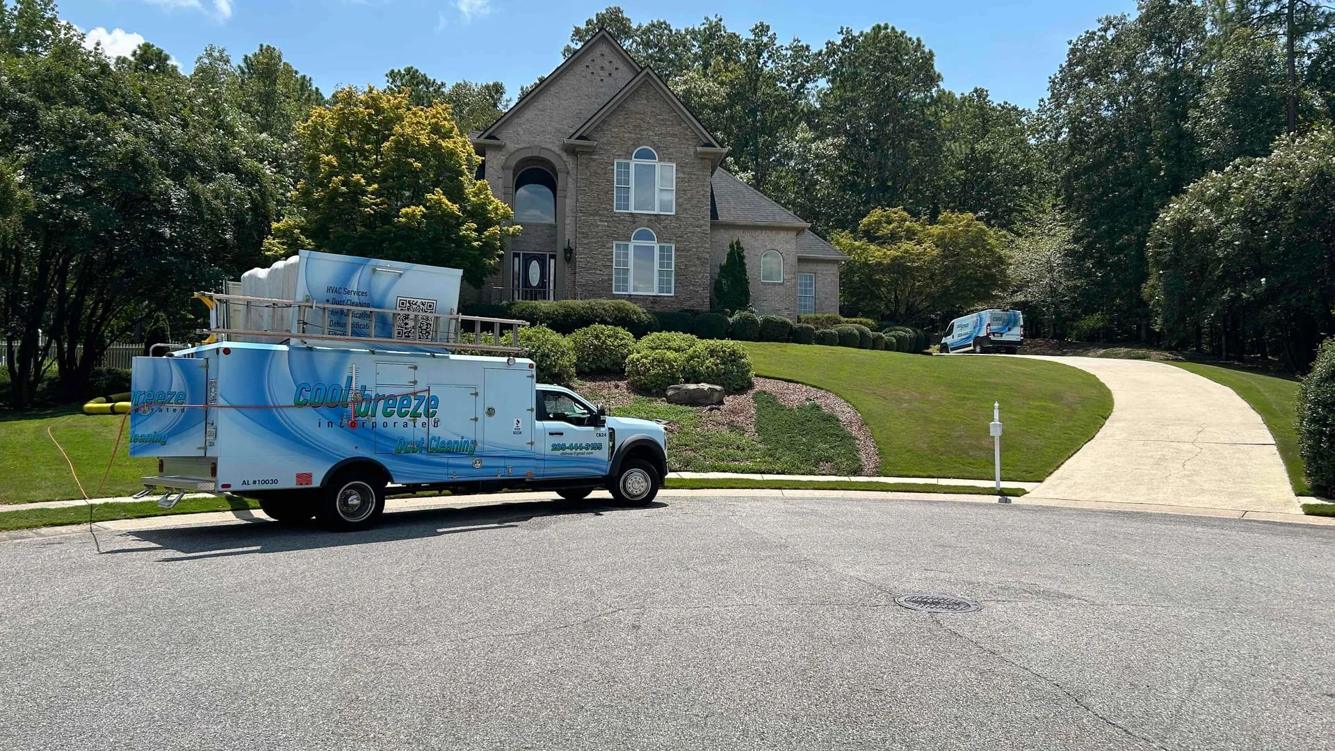 Cool Breeze service vans outside a Birmingham-area home